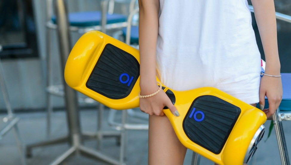 holding a hoverboard